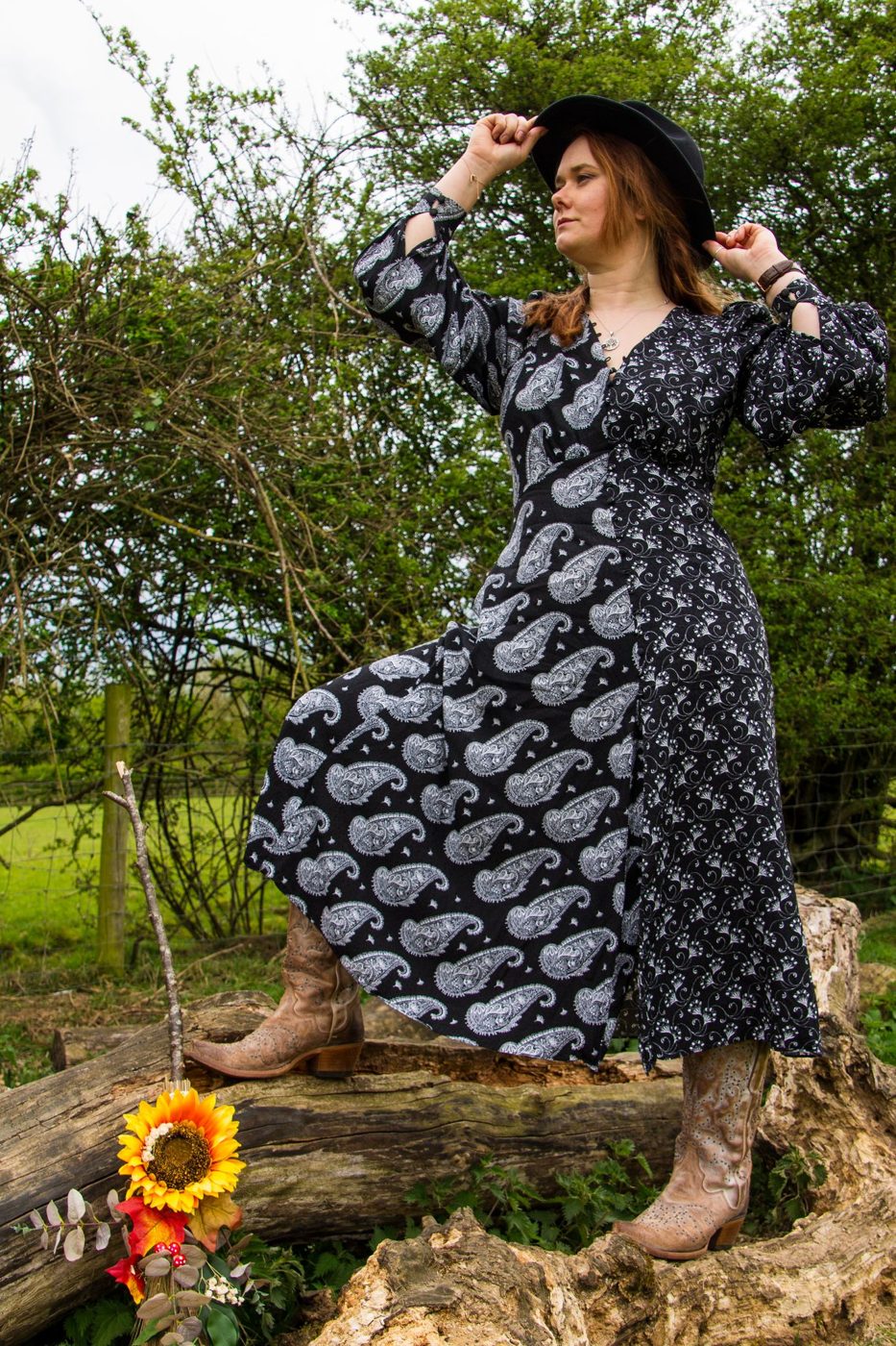 Hannah Collins balancing on a log under the trees
